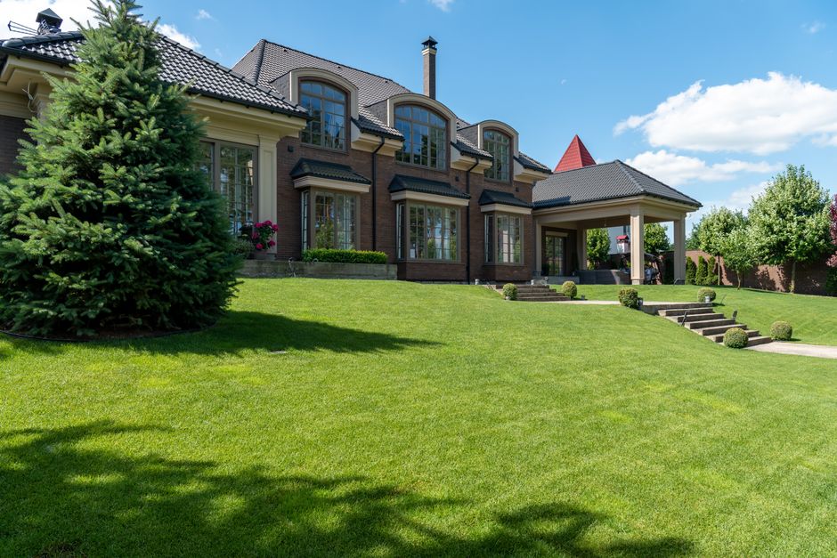 Perfect green suburban lawn surrounding beautiful home